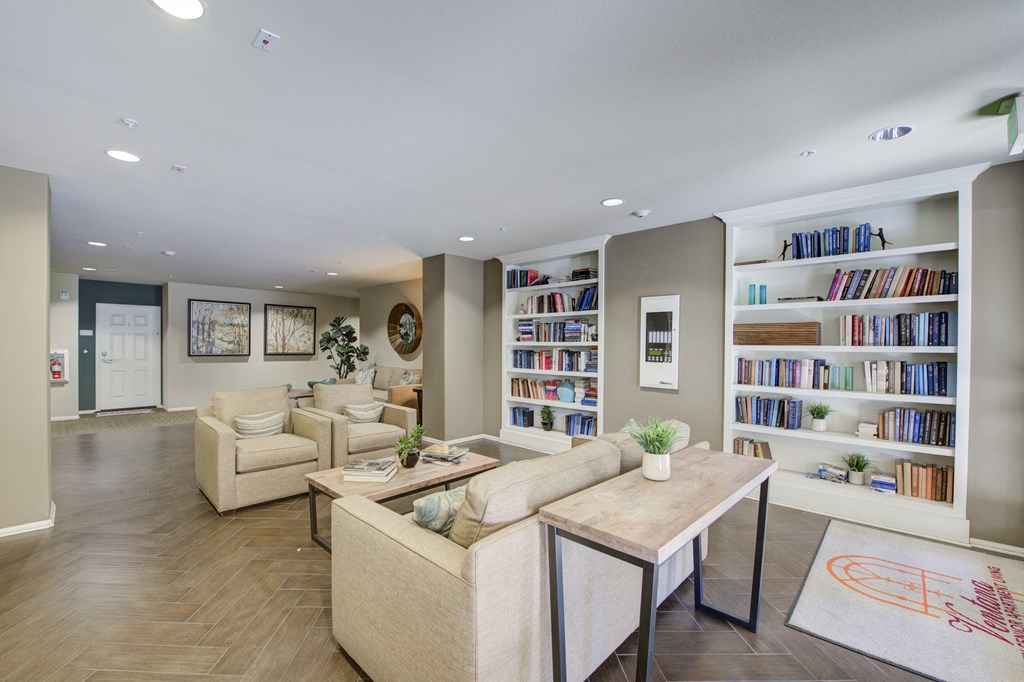 a living room filled with furniture and a large bookshelf  at Ventana Senior Apartments, Northridge, CA, 91326