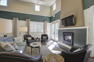 a living room with a fireplace and a tv  at Ventana Senior Apartments, Northridge, 91326 - Photo Gallery 4