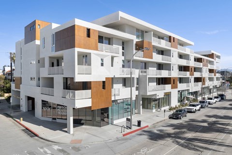 A modern multi-story building with a white and brown facade.