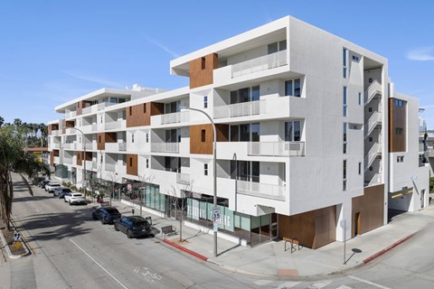 A modern apartment building with white and brown exterior.