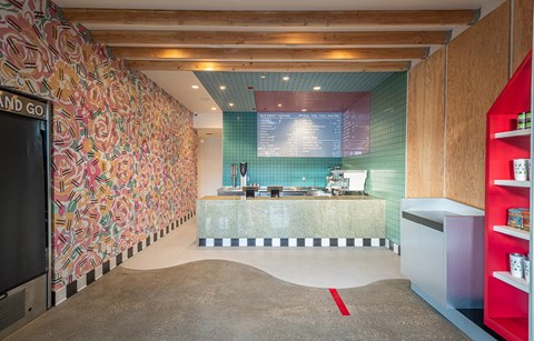 A kitchen with a counter and a wall with a floral pattern.