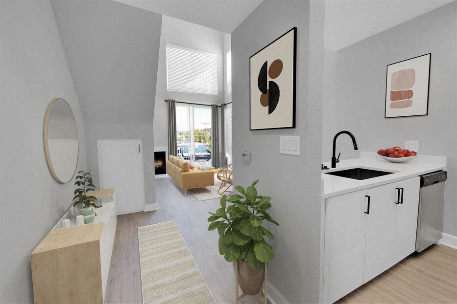 a kitchen and living room with a sink and a mirror