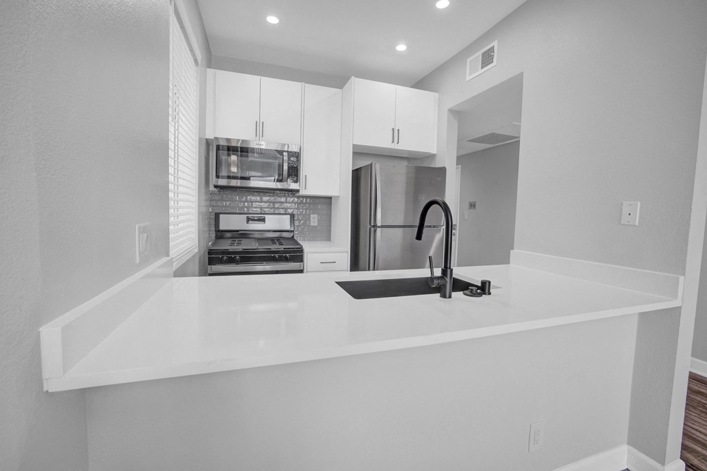 the kitchen of a new home with a large white counter top
