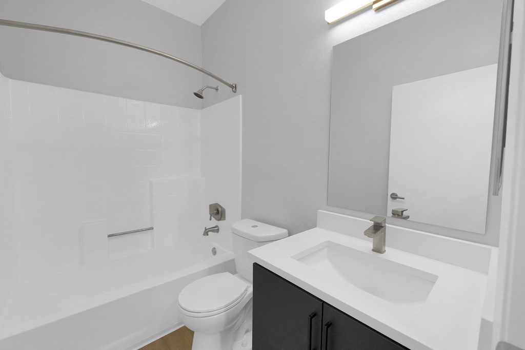 an empty bathroom with a sink toilet and shower