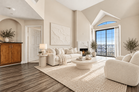 A modern living room with a fireplace and a large window.