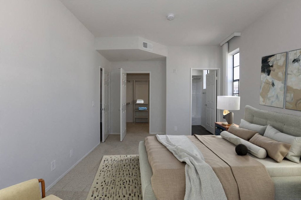 A bedroom with a large bed and a painting on the wall at Burton Apartments, Los Angeles, 90048