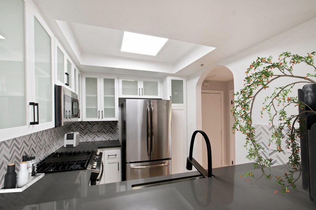 a kitchen with a stainless steel refrigerator and a counter top at Burton, California, 90048