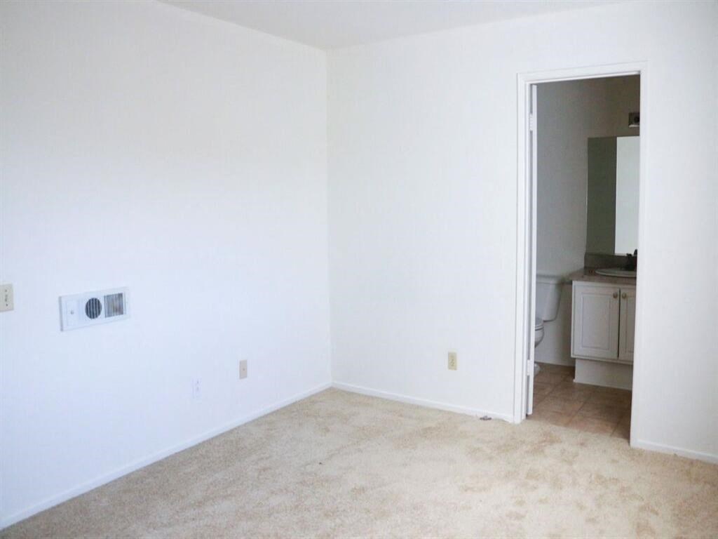 an empty room with a toilet and a sink