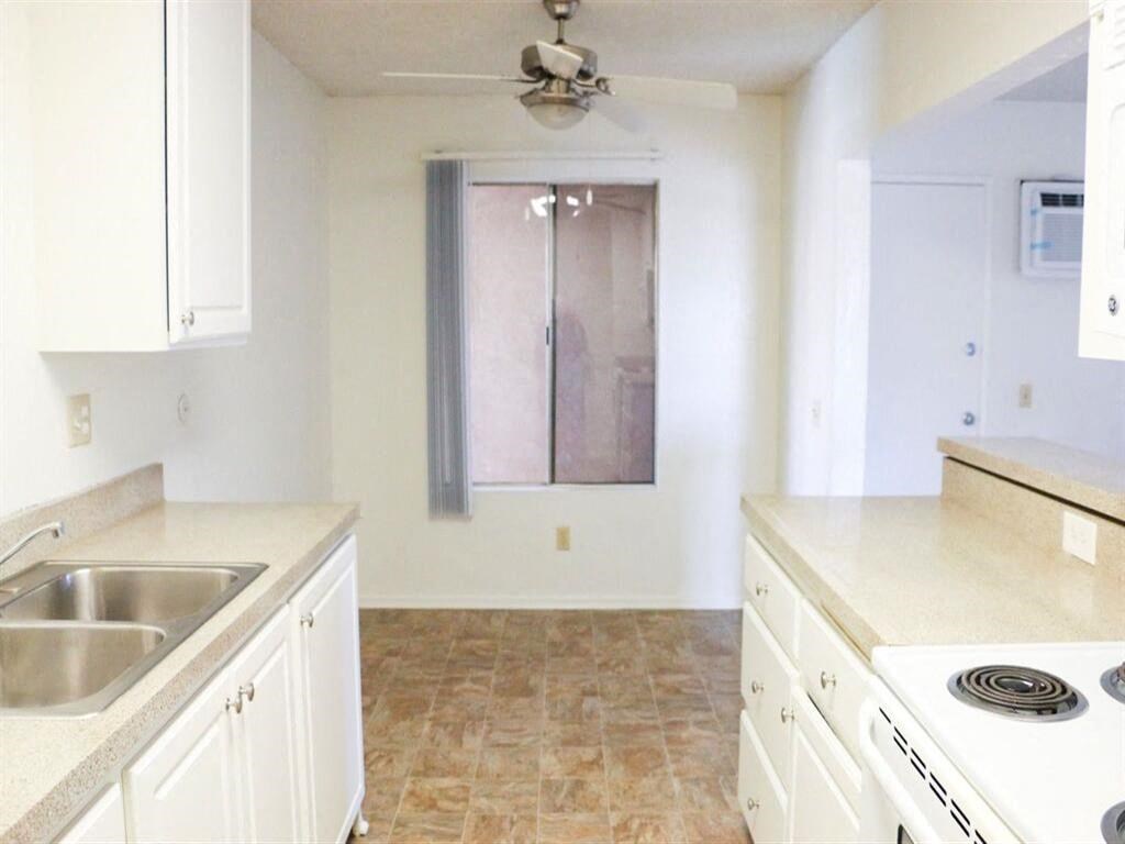 a kitchen with a stove top oven next to a window