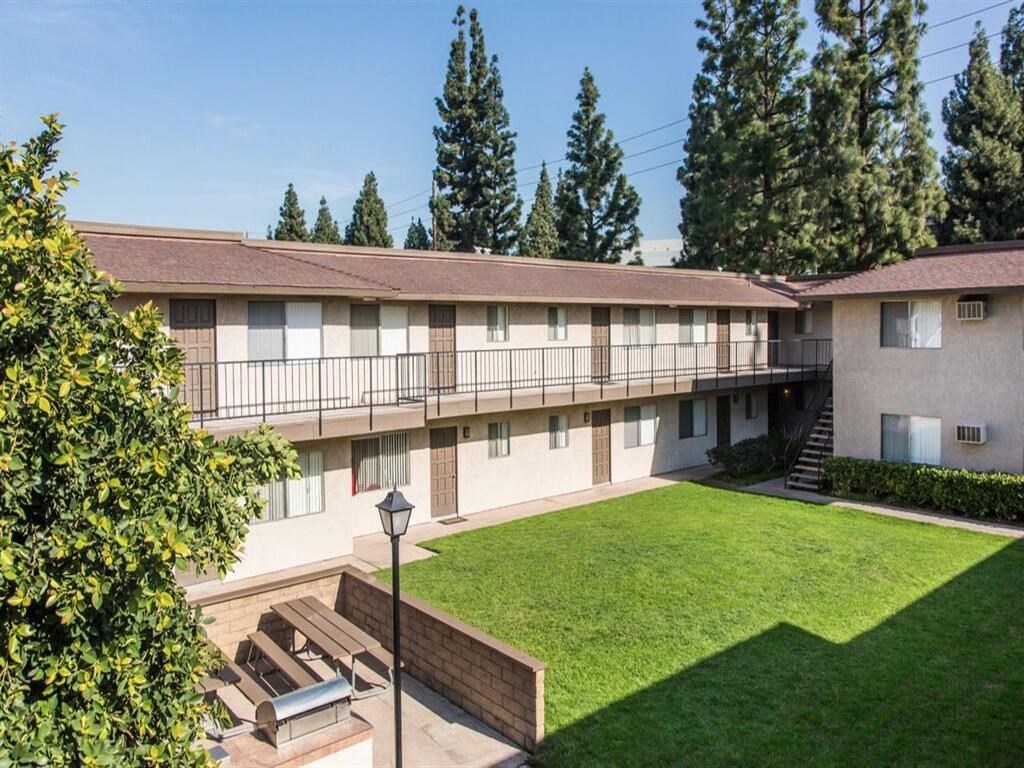 a building with a grassy lawn and a street light in front of it