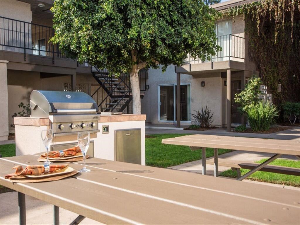 a grill and picnic table in a yard