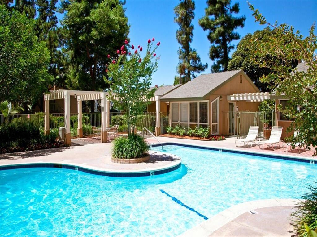 a swimming pool with a house in the background