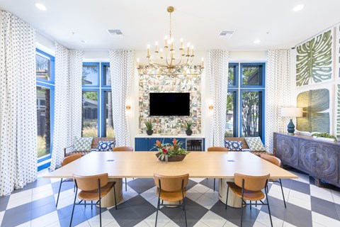 A large dining room with a checkered floor and a chandelier.