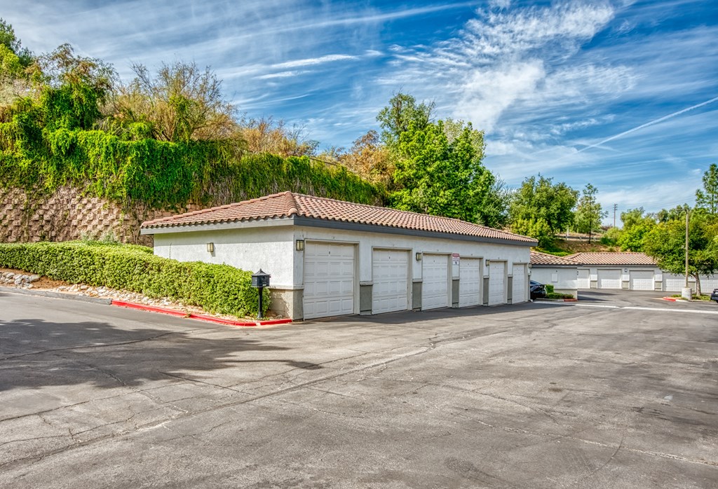 a garage with white doors and a parking lot at Canyon Crest, Riverside, CA