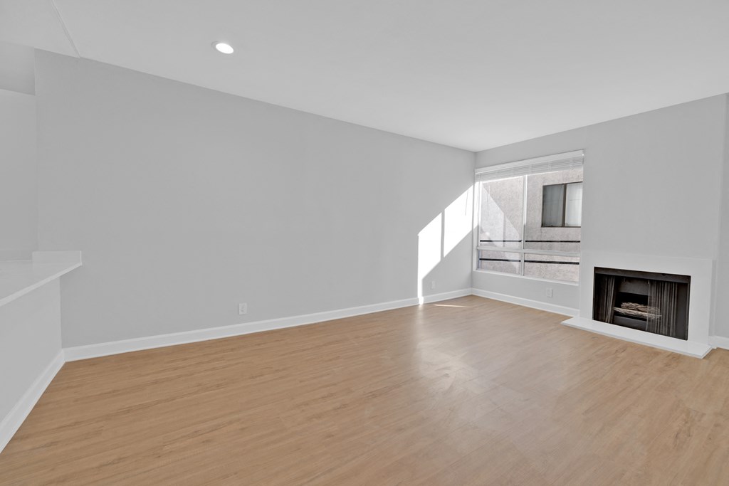 a living room with a fireplace and a wooden floor