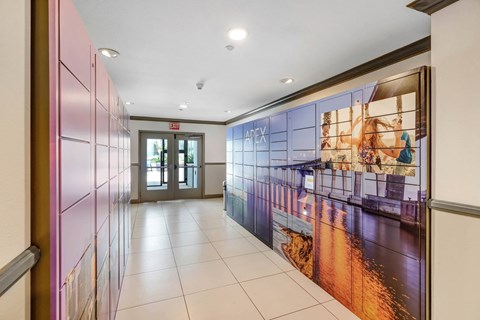 a hallway with a large mural on the wall and a door at the end of the hallway  at Apex Mission Valley, San Diego, California