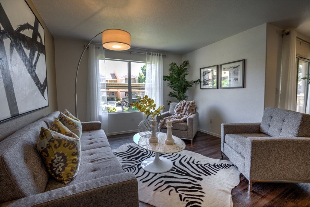 a living room with a zebra rug and couches at Bella Terra Apartments, Nevada