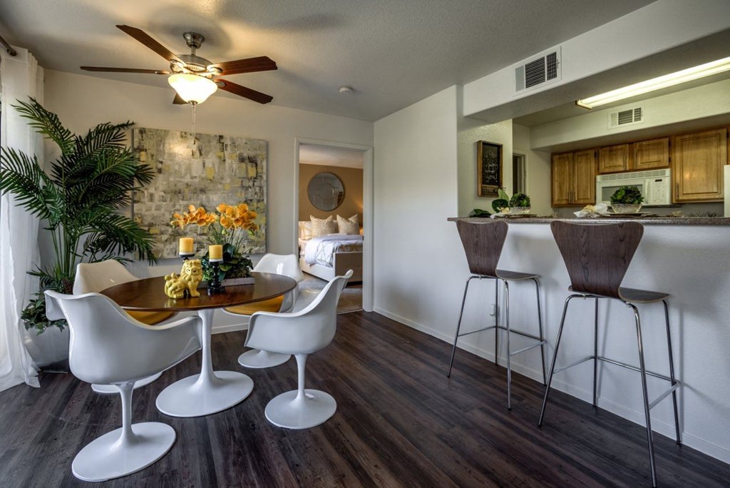 a living room and kitchen with a bar and a table at Bella Terra Apartments, Nevada