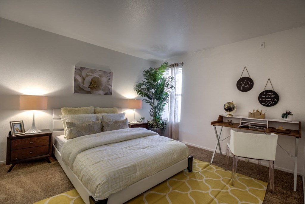 a bedroom with a bed and a desk at Bella Terra Apartments, Henderson