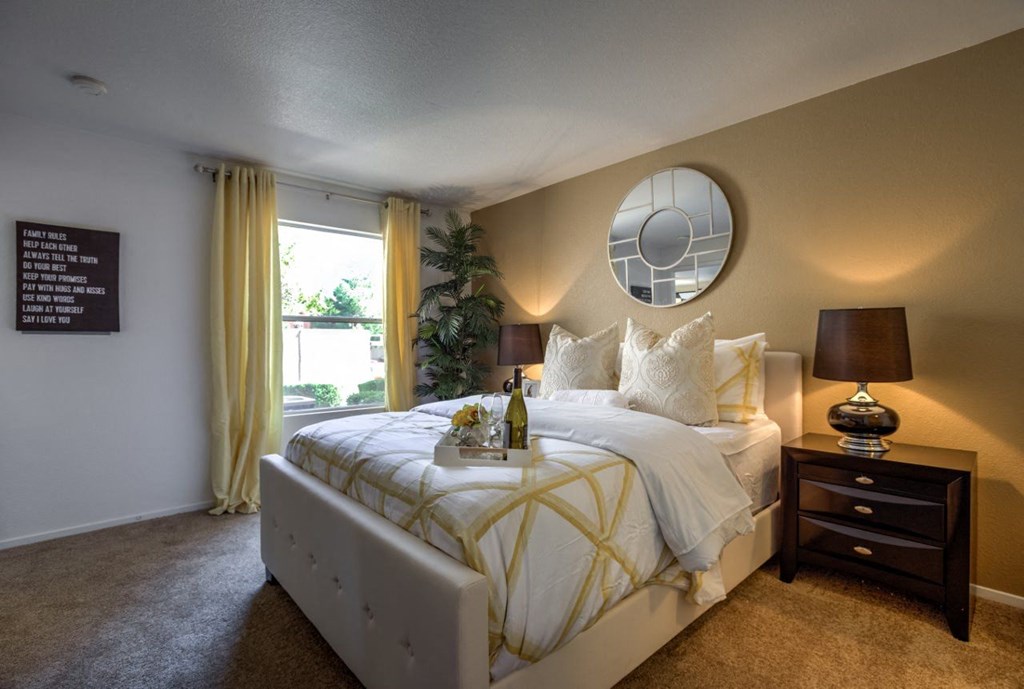 a bedroom with a large bed and a window at Bella Terra Apartments, Henderson