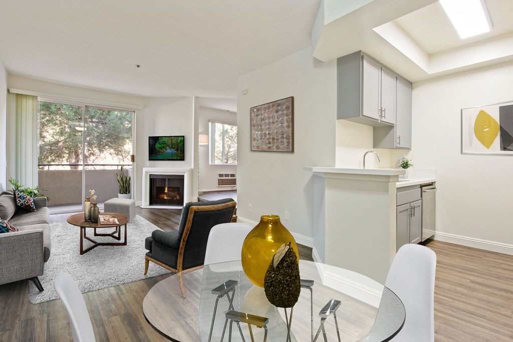 a living room with a glass table and chairs at Palm Royale Apartments, California, 90034