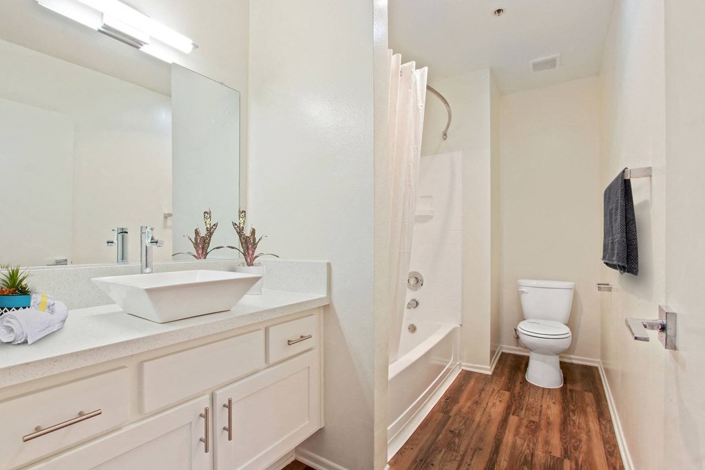 a bathroom with white cabinets at Palm Royale Apartments, California, 90034