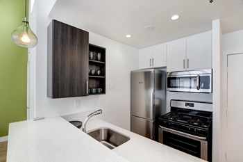 a kitchen with white cabinets and green walls - Photo Gallery 10