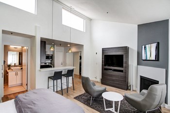 a bedroom with a bed and a chair in a room - Photo Gallery 13