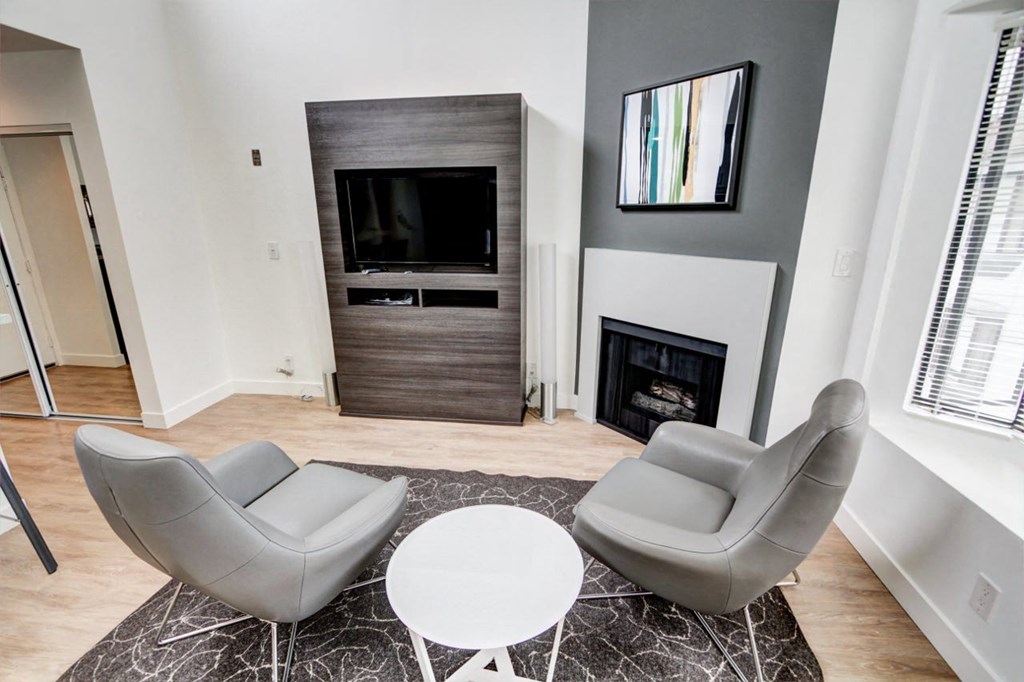 a living room with a fireplace and two couches  at El Greco Lofts, Los Angeles, California