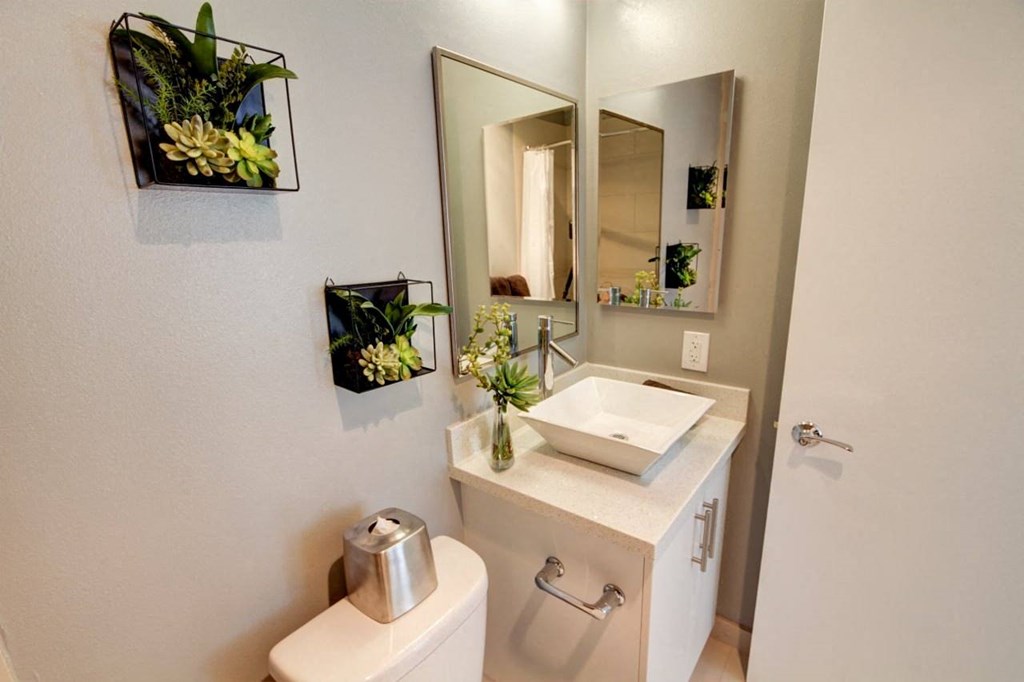 a bathroom with a sink and a mirror  at El Greco Lofts, Los Angeles