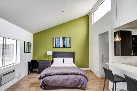 a bedroom with a bed and a desk in a room  at El Greco Lofts, California