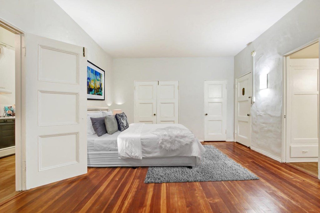 a bedroom with a bed and a door that leads to a bathroom  at 1022 Tiverton, Los Angeles, CA