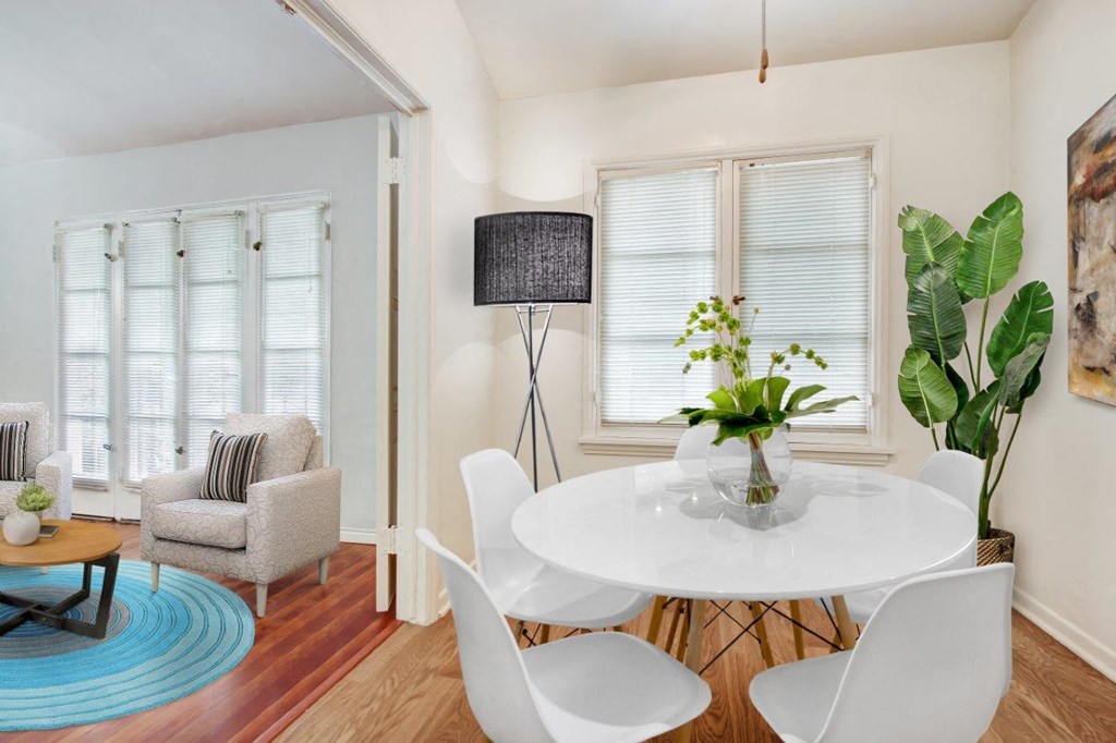 a dining room with a round table and white chairs  at 1022 Tiverton, Los Angeles, CA, 90024