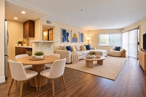 A modern living room with a dining table and chairs.