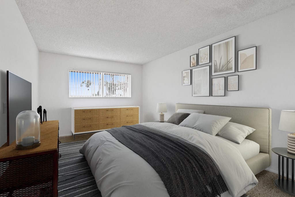 a bedroom with a bed and pictures on the wall