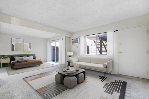 a living room with a couch and a coffee table    and a bed