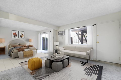 A modern living room with a white sofa, a grey coffee table, and a yellow ottoman.