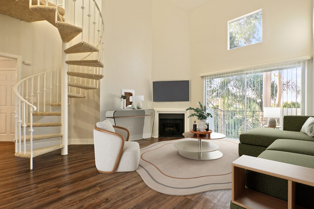 A living room with a spiral staircase and a fireplace at Playa Summit, Los Angeles, CA