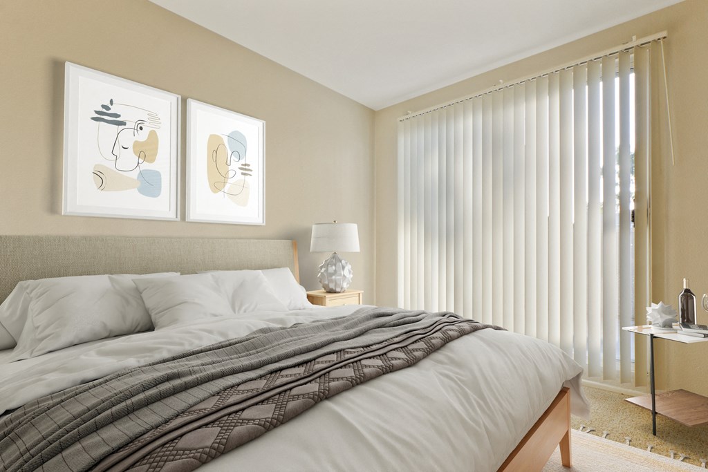 A bedroom with a bed, two lamps, and two framed pictures on the wall at Playa Summit, Los Angeles, CA