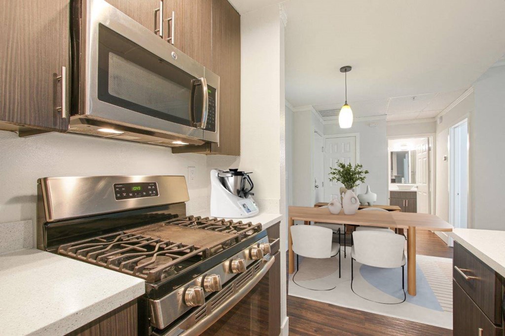 A modern kitchen with a stainless steel oven and microwave at The Plaza Apartments, Los Angeles, CA