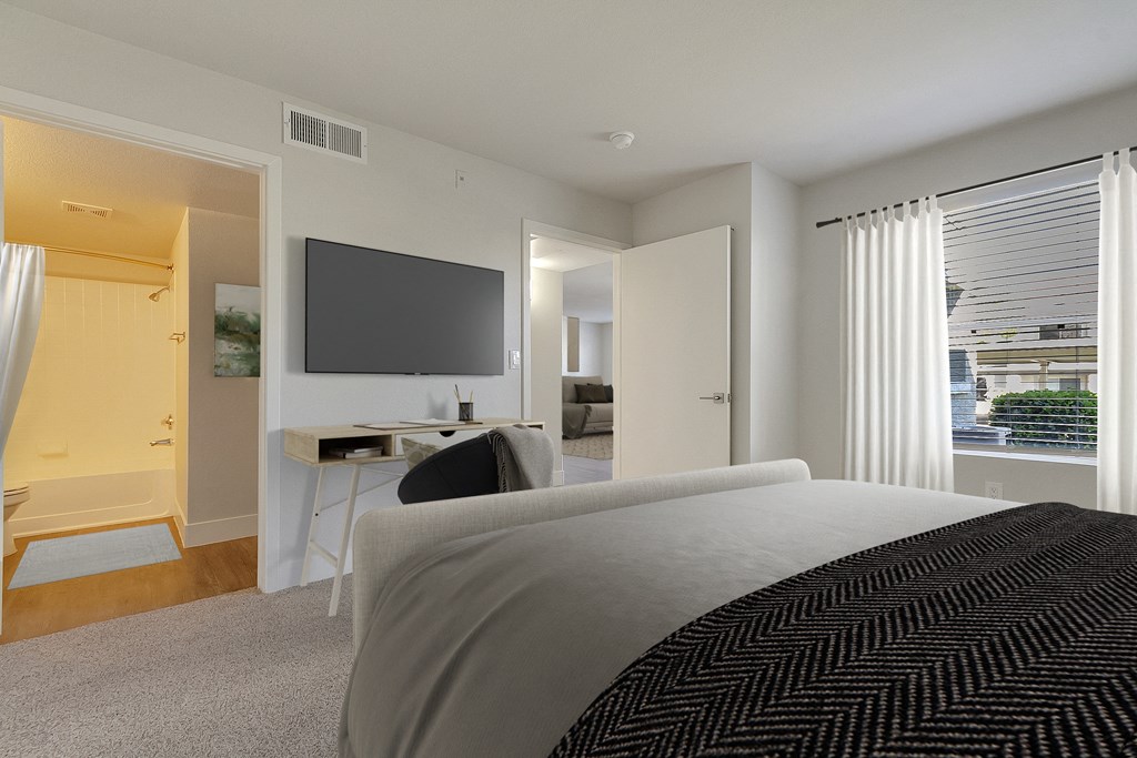 a bedroom with a bed and a desk and a tv at Bella Terra Apartments, Henderson, NV