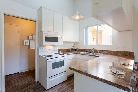 a kitchen with white appliances and a counter top