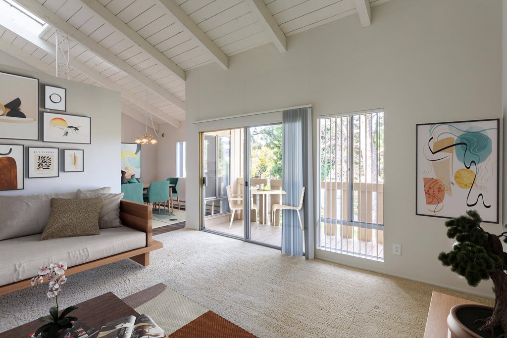 a living room with a couch and a sliding glass door to a patio