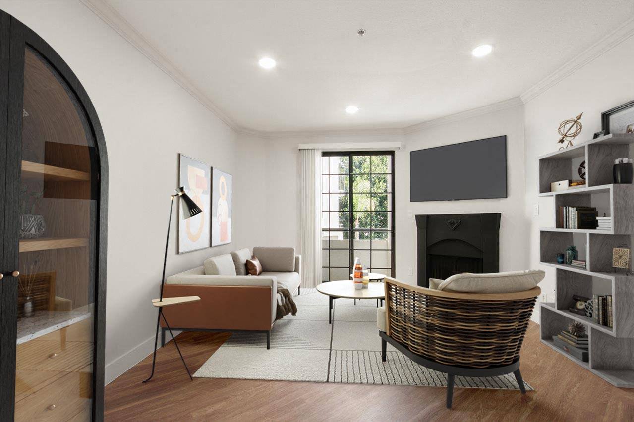 a living room with a couch and a chair and a fireplace