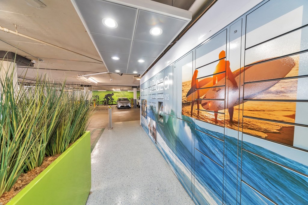 a mural of a person on a surfboard is painted on the wall of an office corridor  at The Plaza Apartments, Los Angeles, California
