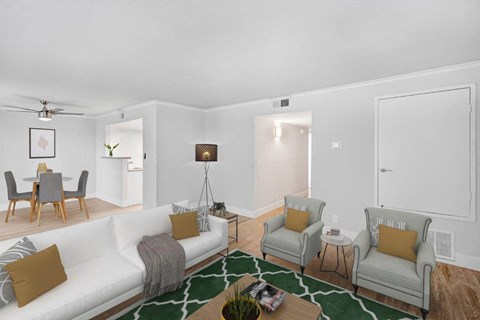 a living room with a couch and two chairs