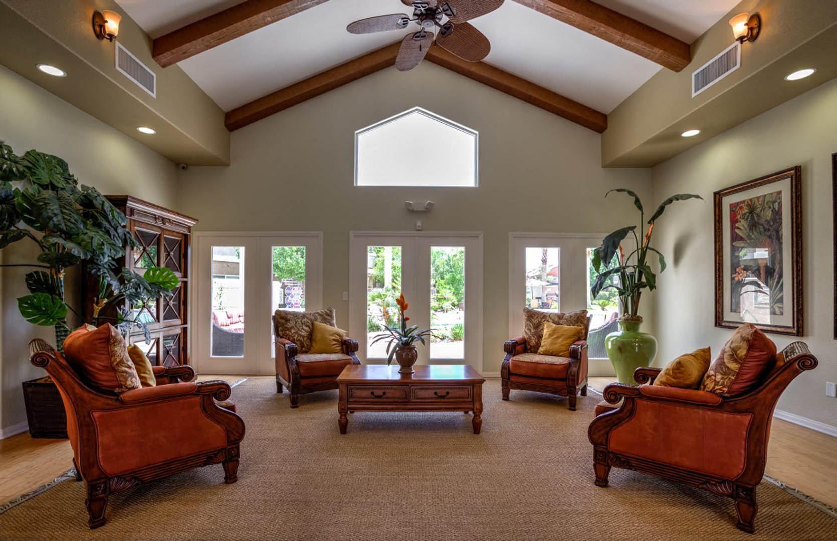 a large living room with furniture and a ceiling fan
