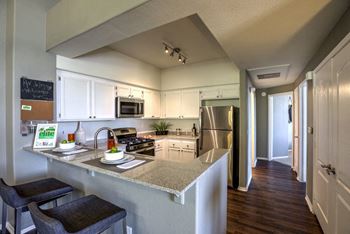 Kitchen with cabinets and appliances at Milan Apartment Townhomes, Las Vegas