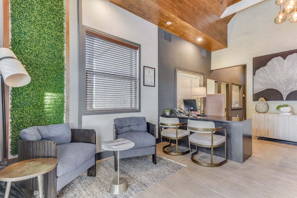 a living room with a table and chairs and a kitchen