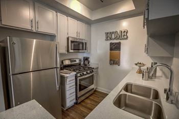 Kitchen area with appliances at Palm Royale Apartments, Los Angeles, CA